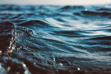 Deep Blue Sea Water Surface with Ripples and Sunlight Glimmering Creating Abstract Patterns in Soft Focus