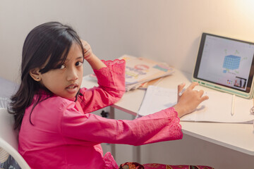 An Indonesian female student who seemed confused about doing her homework