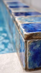 Close Up of Blue and Aqua Swimming Pool Tiles Bordering Refreshing Water Body with Glistening Details Under Bright Natural Lighting