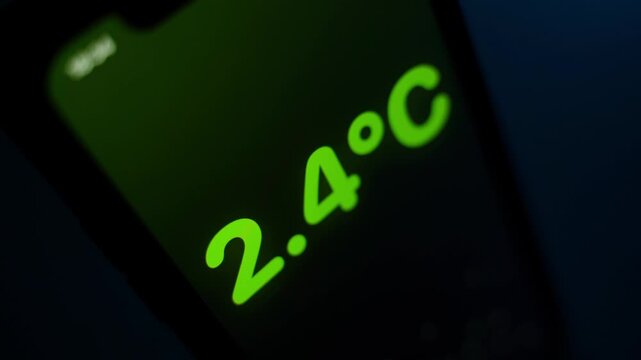 Sharply dropping temperature in Celsius, close-up. Phone screen showing temperature drop