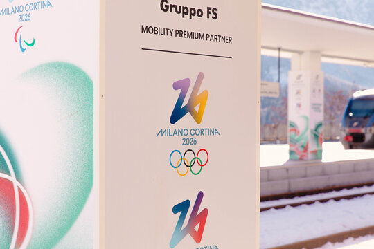 Cortina, Italy - January 27, 2026: Milano Cortina 2026 Olympic Games signage featuring logos and branding for Gruppo FS as a mobility premium partner at a train station