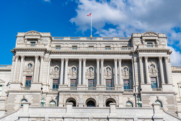Obraz premium Congress building under blue sky. Washington DC landmark. American flag above the Congress library. USA Congress. Congress historic symbol of American democracy
