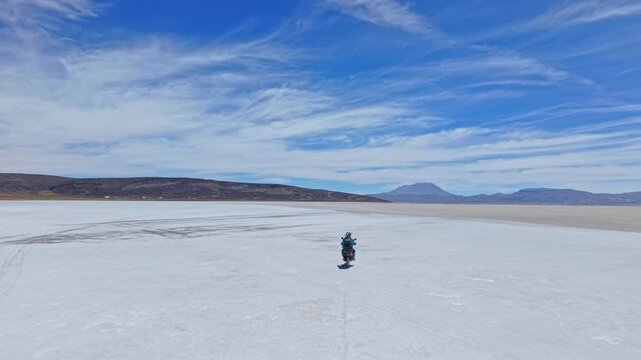 Two travellers ride across the salt flats toward Ubinas Volcano, with vast open space and surrounding volcanic peaks highlighting the scale, remoteness and raw beauty of Peru&rsquo;s high-altitude landscape