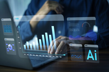 Businessman using computer and AI with charts and data to plan investment and business strategy.