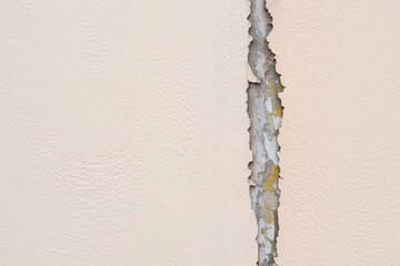 Broken plan fixed plan Cracked beige wall texture with exposed concrete and yellowing