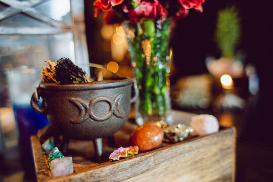 Crystal gemstones and plants in bowls and a small cauldron in a metaphysical witch home goods shop