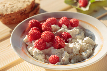 Ricotta or cottage cheese with fresh raspberries.