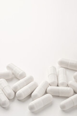 White pills on a white background. Close up