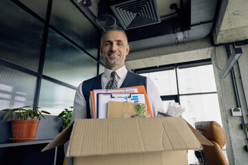 Hired man hold box with his personal stuff in office. Businessman got hired job. Taking box with personal stuff to office. Guy got job. Hired manager in company. Hiring employee. Man office worker