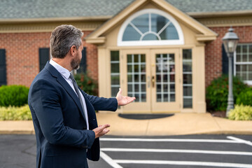 Real estate purchase and sale. Insurance agent. Professional realtor offering house to buyer. Businessman broker. Insurance business. Real estate broker at house. House for sale. Presenting product