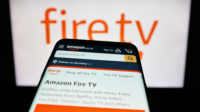 Stuttgart, Germany - 01-22-2026: Mobile phone with website of digital media player Amazon Fire TV on screen in front of logo. Focus on top-left of phone display.