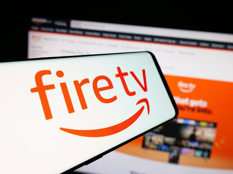 Stuttgart, Germany - 01-22-2026: Smartphone with logo of digital media player Amazon Fire TV on screen in front of website. Focus on center-left of phone display.