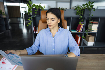Businesswoman with laptop in office. Remote online working. Business success. Businesswoman using laptop in business office. Freelancer working online. Woman CEO negotiating online