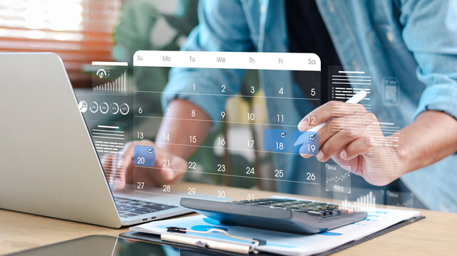 Businessman planning schedule and financial tasks using digital calendar interface on laptop. Concept of time management, accounting, budgeting, and productivity.