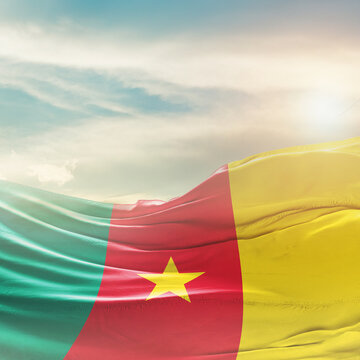 Cameroon national flag waving in sky.