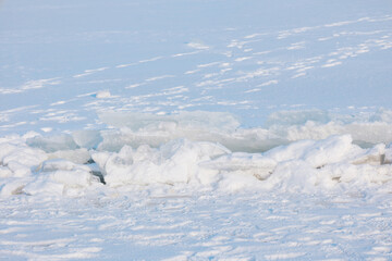 Rough ice floes and crisp snow covering a vast frozen winter landscape under bright sunlight