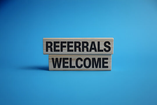 "Referrals Welcome" Visual Concept on Wooden Blocks for Illustration. Minimalist Wooden Blocks Composition.