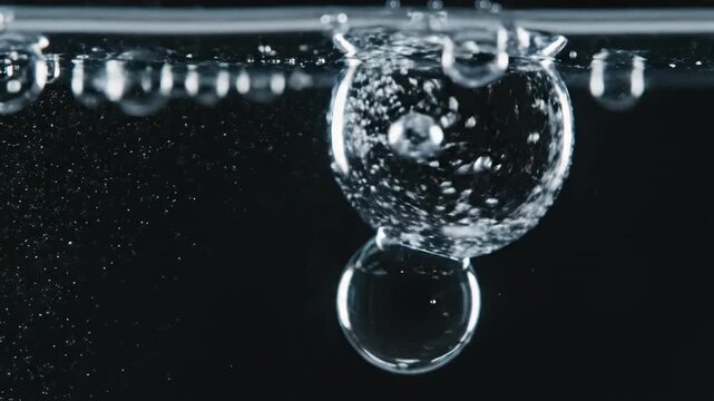 Isolated element shot of large, pure water droplets pulsating and vibrating slightly against an absolute featureless black background science, droplet, macro