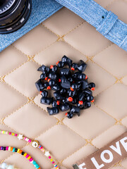 A close-up of a set of black, playful duck-shaped interior figurines arranged on a leather surface.