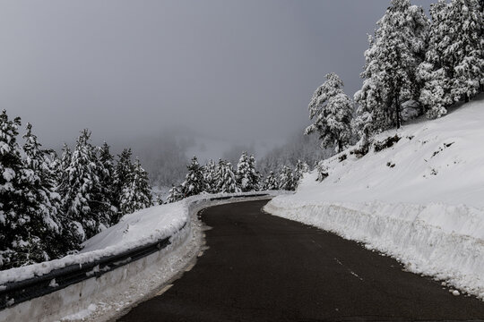 A winding road curves through the snow-covered landscape