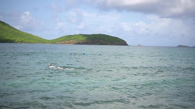 Snorkelers float in shallow water off Tamarindo Beach, Culebra