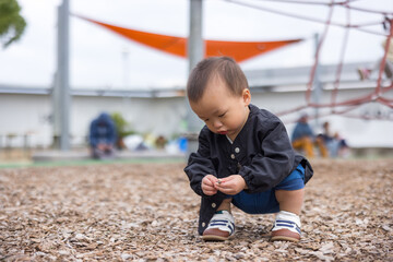 Young baby exploring park area through play