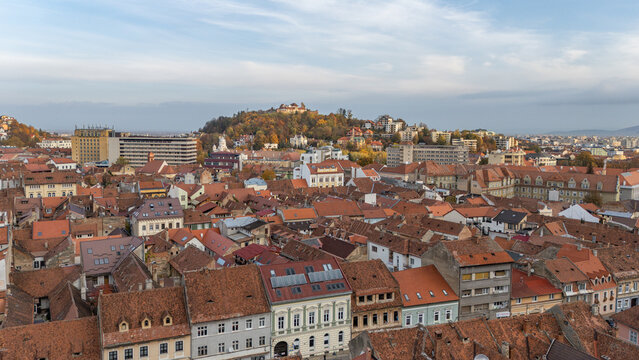 Aerial drone view on streets and city of Brasov,  beautiful houses, Transylvania, Romania. Beautiful famous must-see tourist attraction. Travel destination. Hills, mountains in background.
