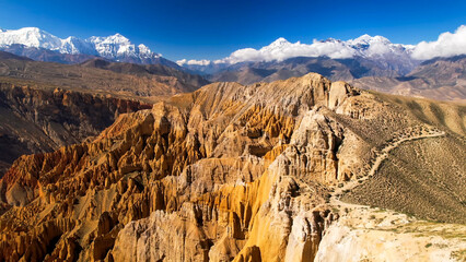 Aerial view of dry mountain slopes and winding trekking trails in Mustang © HABI ANGGARA PUTRA