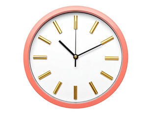 A close-up view of a circular clock with peach frame, gold accents, and black hands