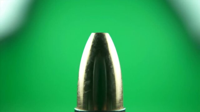 Close up of a bullet against a green screen background