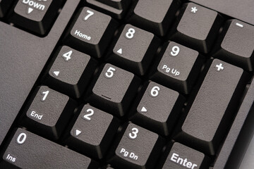 Close up of numeric keypad on computer keyboard representing calculation, number input, digital...