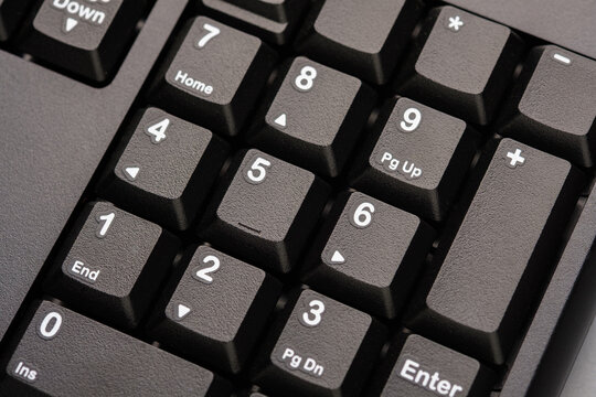 Close up of numeric keypad on computer keyboard representing calculation, number input, digital data entry, password input, and technology based work