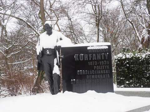 Monument of Wojciech Korfanty covered in snow in a winter city park