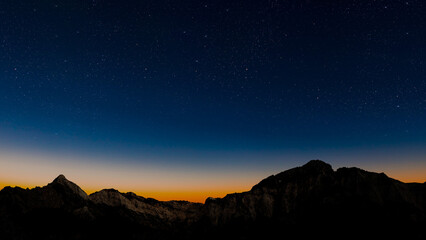 stars in the night sky with the view of mountains. © vovan