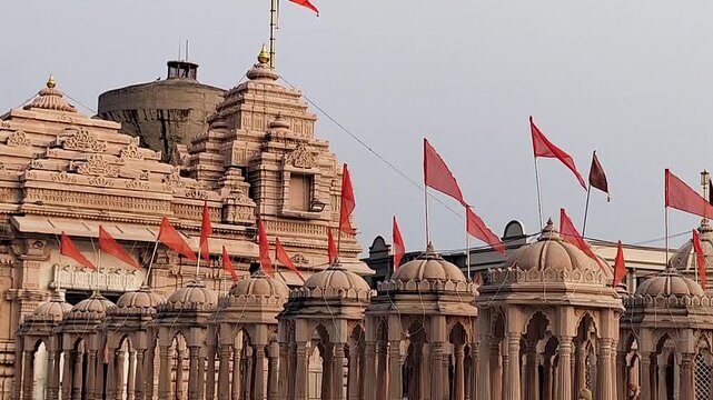 Shri Valinath Mahadev Mandir exterior in Gujarat India featuring stone temple architecture, domes and saffron flags, Hindu religious landmark, spiritual heritage site and cultural travel destination.