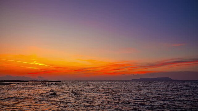 Stunning sunset over Chersonisos beach, Greece with vibrant colors, timelapse
