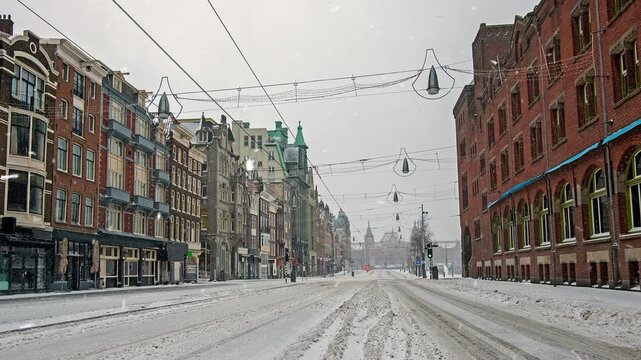 Snowfall on Empty European City Street During Winter