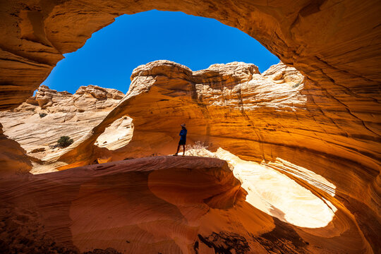 Man in Arizona Sandstone Alcove Arch