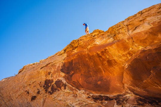 Hiker Looking For Rock Art on Utah Desert Walls