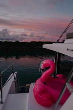 Pink Sunset Reflection with Inflatable Flamingo on Catamaran
