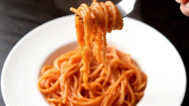Delicious plate of spaghetti with tomato sauce and fork