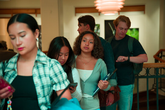 Young adult students waiting in line at college campus