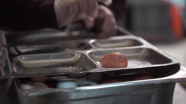 Distribution of food in the dining room. Get in line for a portion of food. The cook puts food in a tray. High quality video