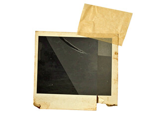 Vintage polaroid frame with attached aged paper pieces, appearing slightly torn, isolated on black