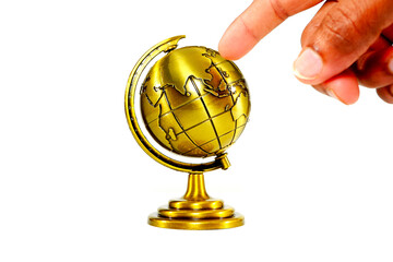 Finger interacting with a metallic golden globe emphasizes worldwide connectivity, global business...