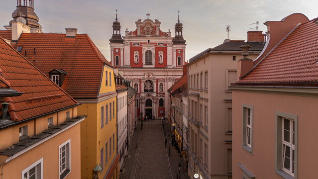 5 march 2025, Poznan, Poland. Aerial, drone view on Collegiate Basilica of Our Lady of Perpetual Help from Świętosławska street. View on baroque basilica, richly decorated pink facade with pilasters a