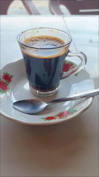 Aceh coffee is served in a clear glass with a distinctive spiced taste and aroma accompanied by delicious, rich Acehnese fried rice