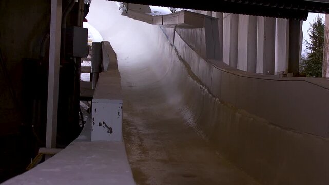 Luge athlete racing down the ice track