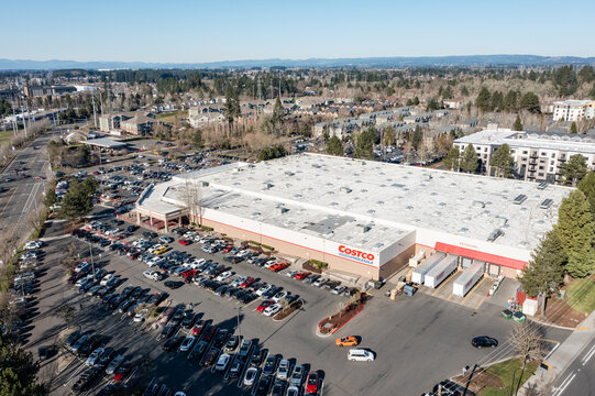 Beaverton, Oregon, USA - Jan 24, 2026 - Aerial drone photo of Costco Wholesale store showing the large warehouse building, busy customer parking lot, delivery loading area, surrounding streets 