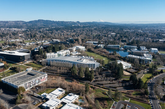 Beaverton, Oregon, USA - Jan 24, 2026 - Aerial drone photo of Nike World Headquarters campus showing multiple Nike office buildings, corporate facilities, parking areas, internal roads, and greenery 
